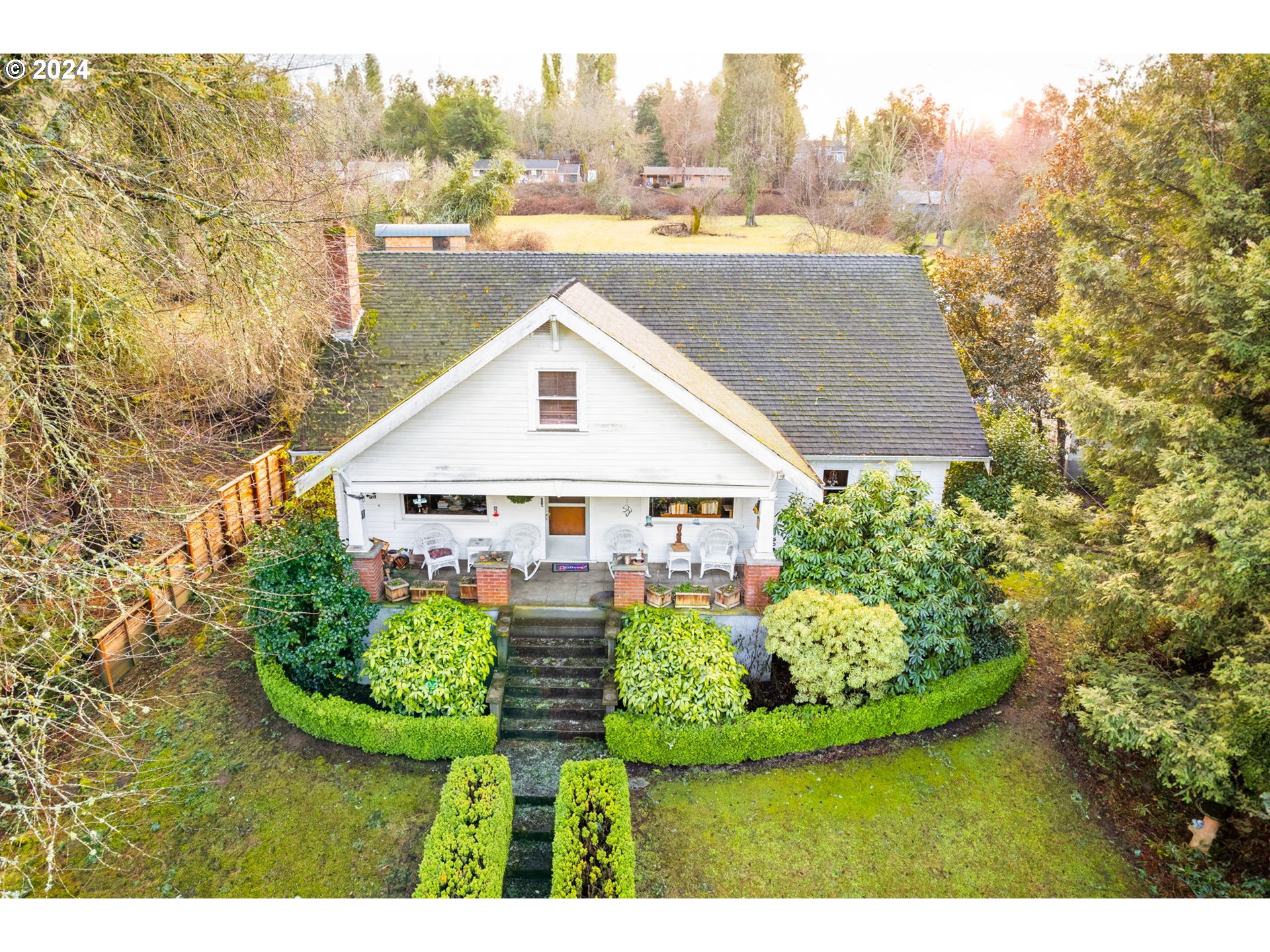 6140 South Canby Street Portland, OR 97219 - Photo 1 of 8 a view of a house with a yard and potted plants