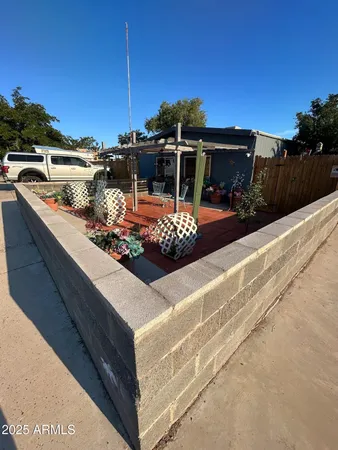 a view of a couches and tables under an umbrella on the roof deck