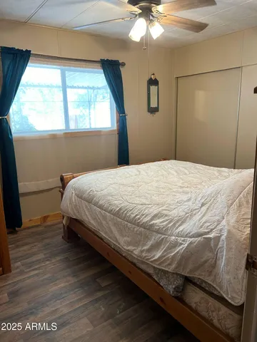 a bed sitting in a bedroom next to a window