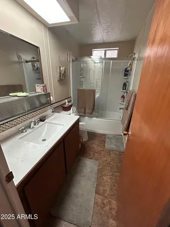 a spacious bedroom with a bed and a chandelier