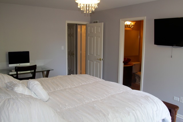 260 Timber Ridge Lane, Unit A Lake Barrington, IL 60010 - Photo 10 of 20 a bedroom with a bed and a flat tv screen on wall