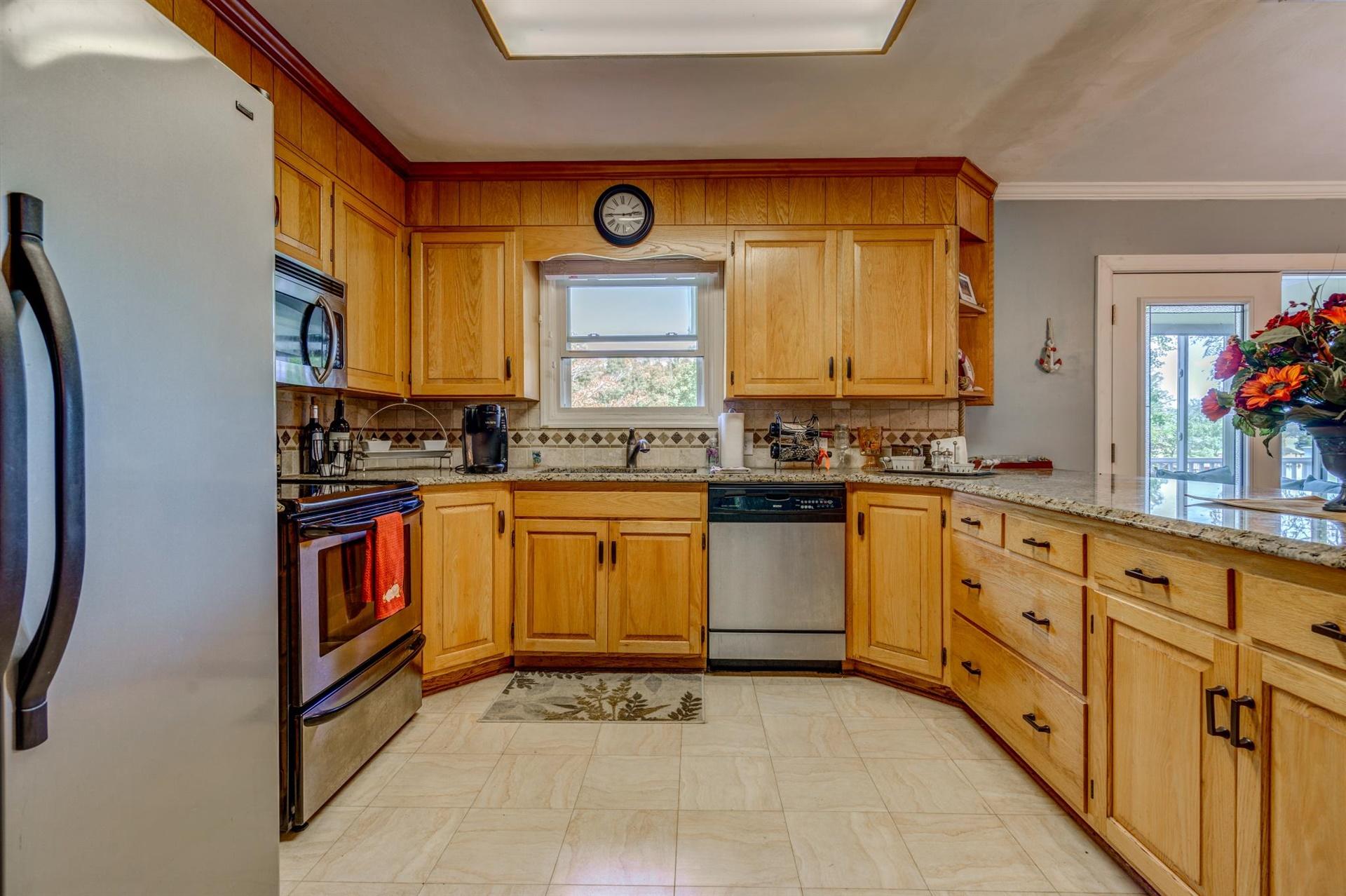 411 Monte Vista Road Union Hall, VA 24176 - Photo 11 of 45 a kitchen with stainless steel appliances granite countertop a stove a sink and a microwave