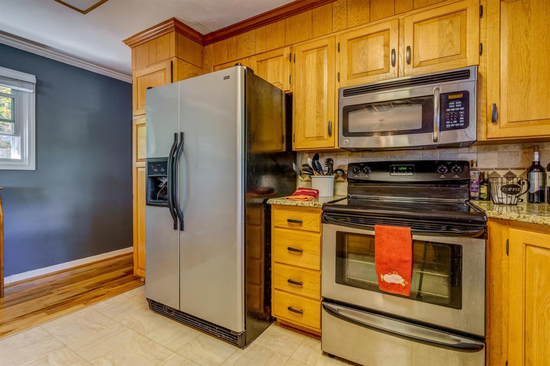 411 Monte Vista Road Union Hall, VA 24176 - Photo 12 of 45 a kitchen with stainless steel appliances granite countertop a stove and a microwave