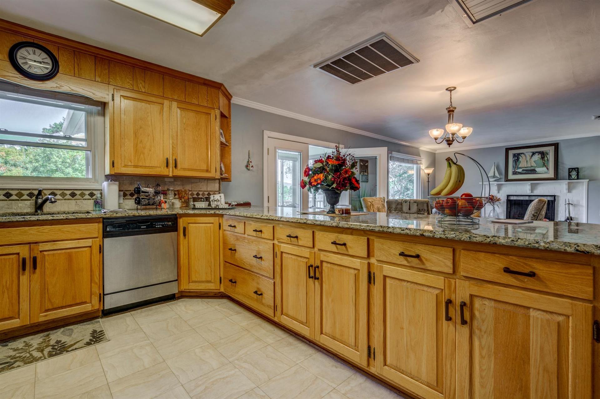 411 Monte Vista Road Union Hall, VA 24176 - Photo 13 of 45 a kitchen with granite countertop a stove sink and cabinets