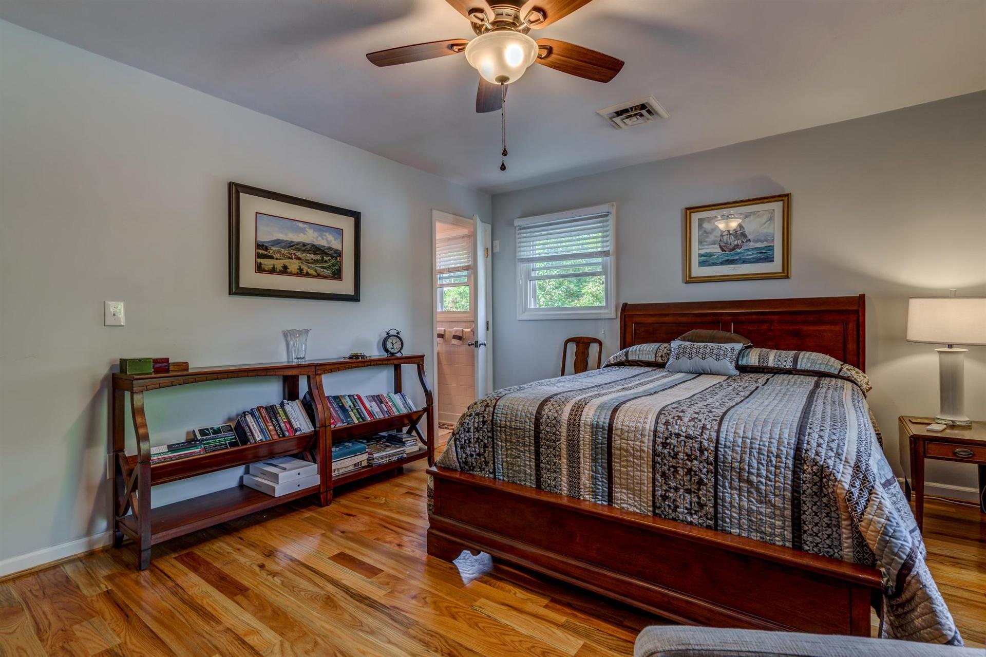 411 Monte Vista Road Union Hall, VA 24176 - Photo 15 of 45 a bedroom with a bed and a chandelier