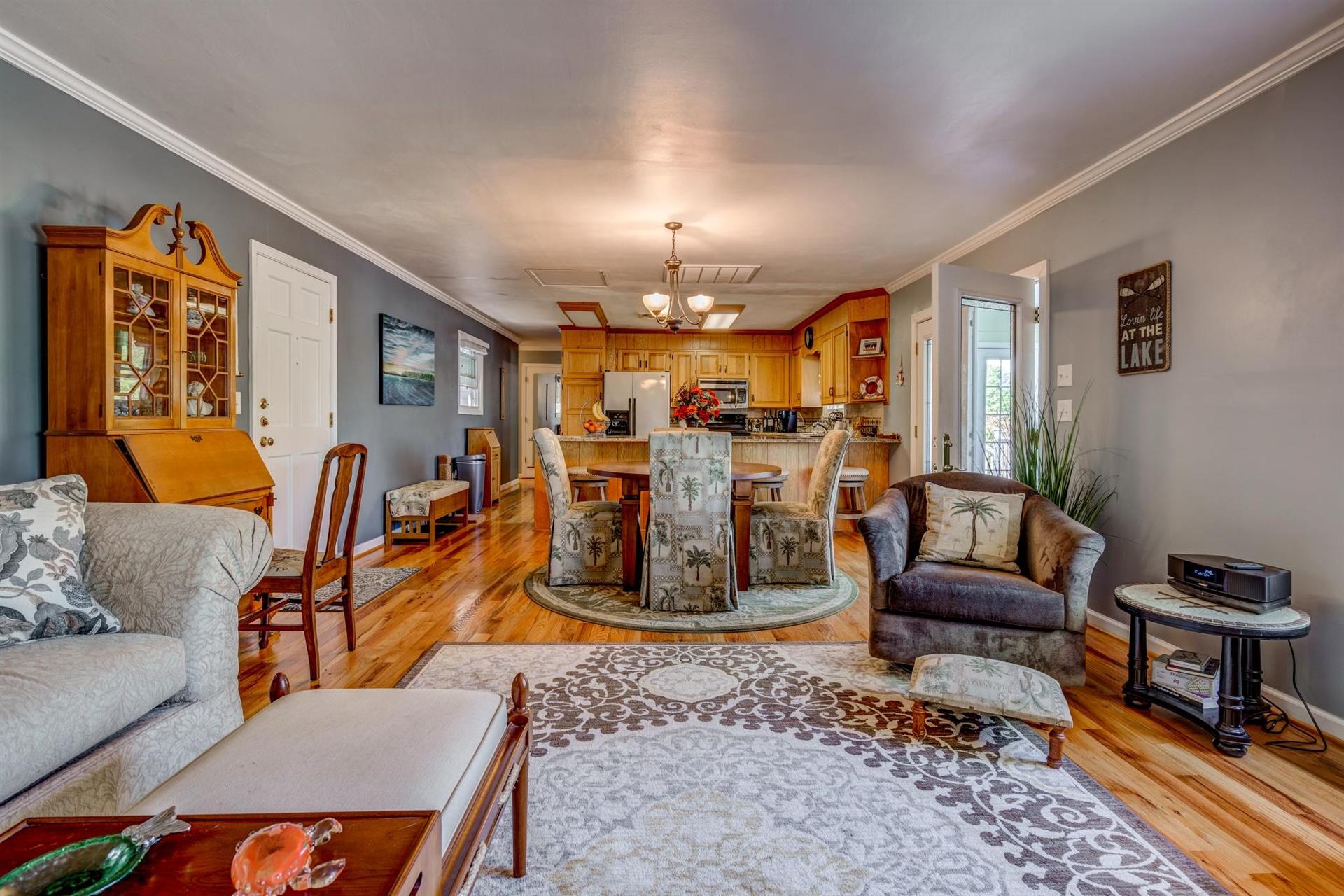 411 Monte Vista Road Union Hall, VA 24176 - Photo 8 of 45 a living room with furniture a rug and a chandelier