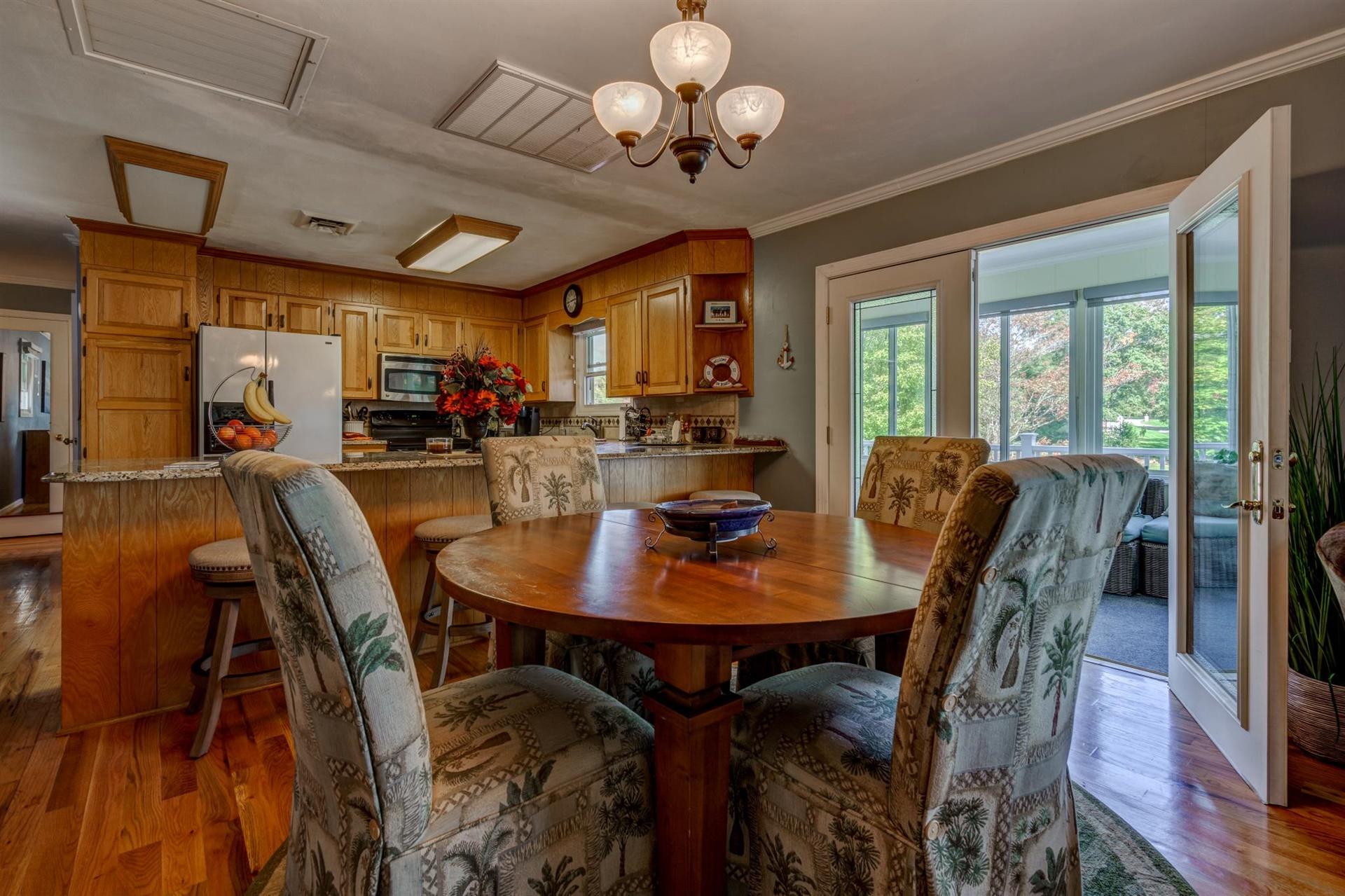 411 Monte Vista Road Union Hall, VA 24176 - Photo 9 of 45 a view of a dining room with furniture window and wooden floor