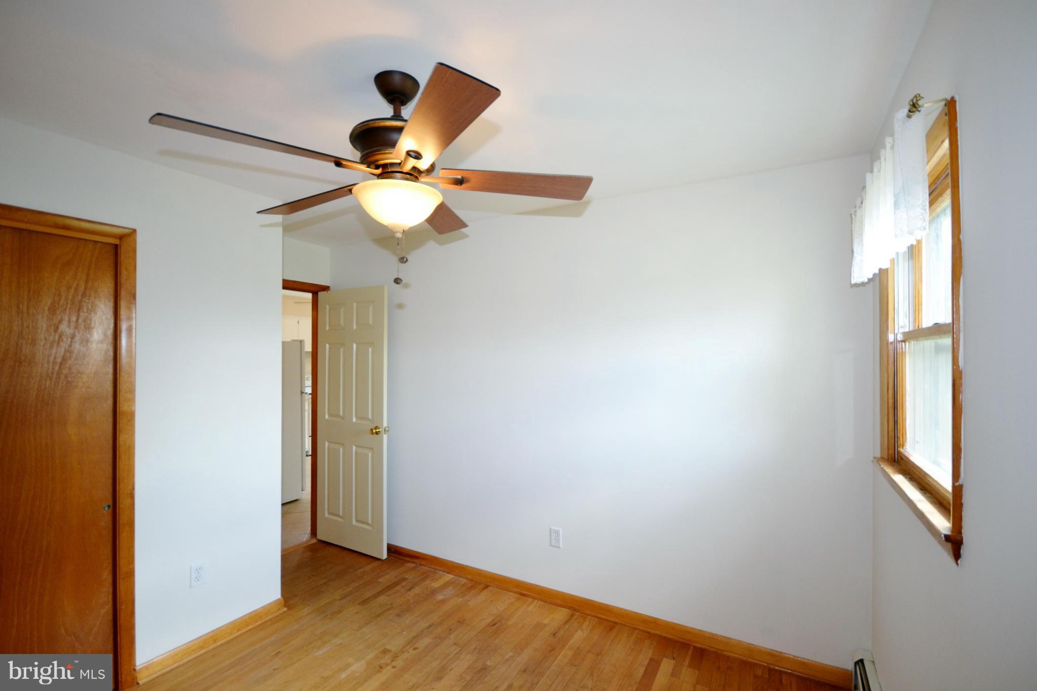 1031 Muller Road Westminster, MD 21157 - Photo 17 of 30 Bedroom has nice windows, hw floors, and fan