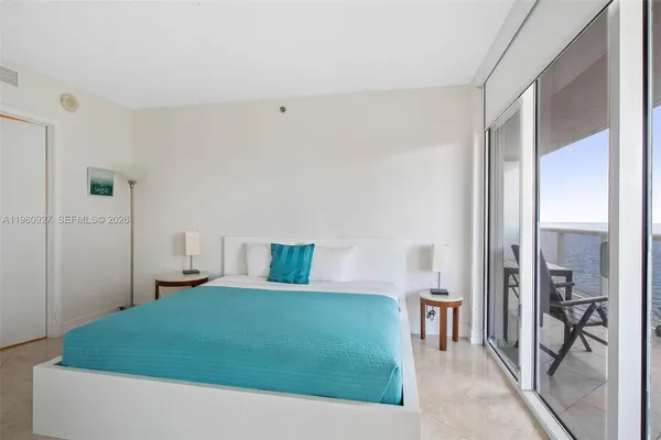 a bedroom with a bed and a table