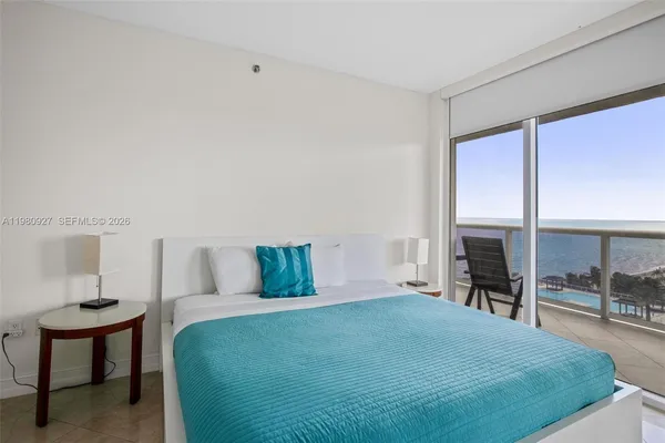 a bedroom with a bed and a table