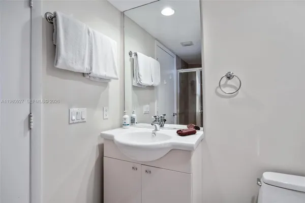 a bathroom with a sink vanity and mirror
