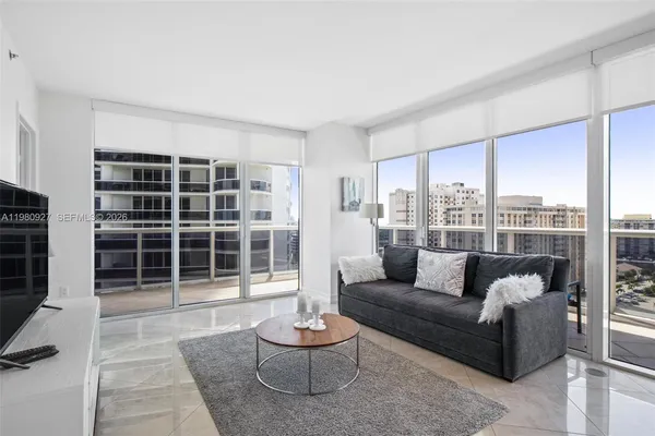 a living room with furniture and a large window