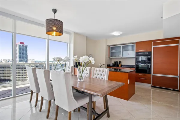 a view of a dining room with furniture and a kitchen
