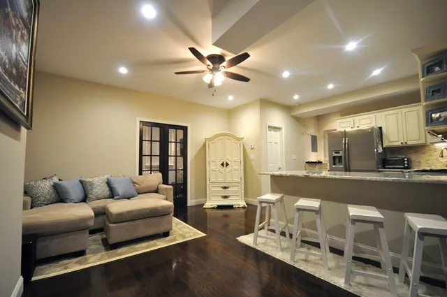 a living room with furniture and a chandelier