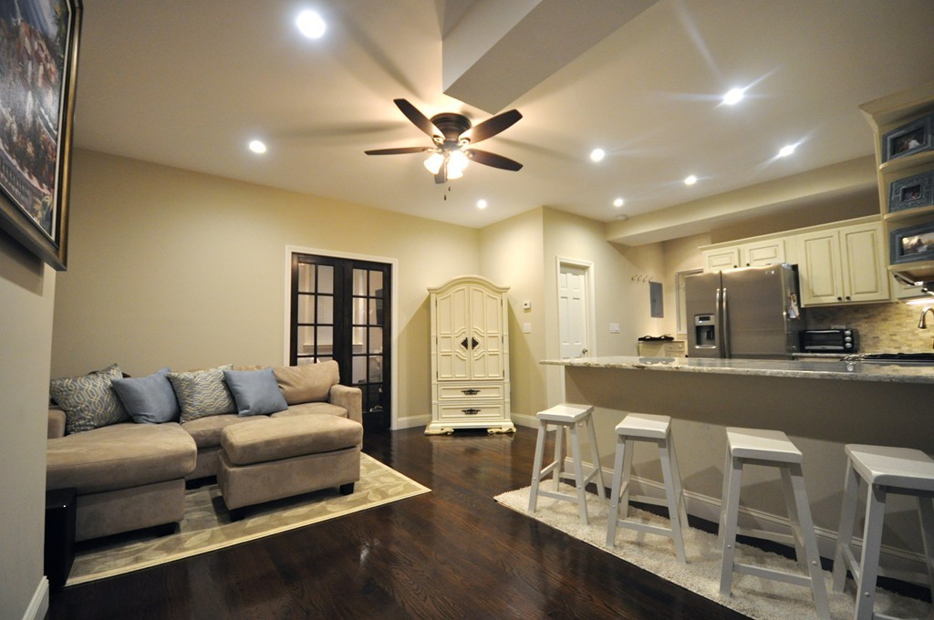 591 Beacon Street, Unit G Boston, MA 02215 - Photo 2 of 9 a living room with furniture and a chandelier
