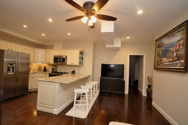 a kitchen with stainless steel appliances a refrigerator stove microwave and cabinets