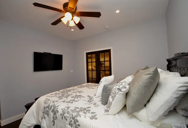 a bedroom with a bed and a flat screen tv