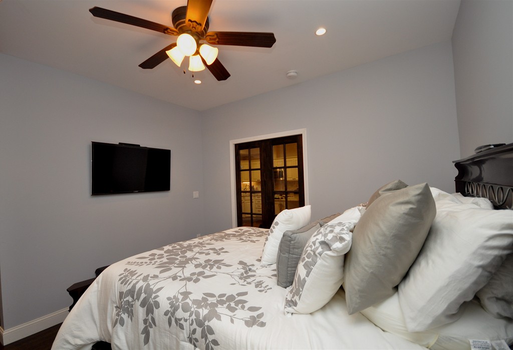 591 Beacon Street, Unit G Boston, MA 02215 - Photo 8 of 9 a bedroom with a bed and a flat screen tv