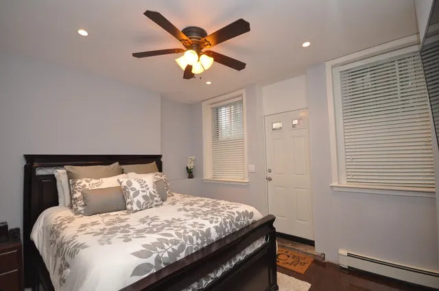a bedroom with a large bed and a chandelier