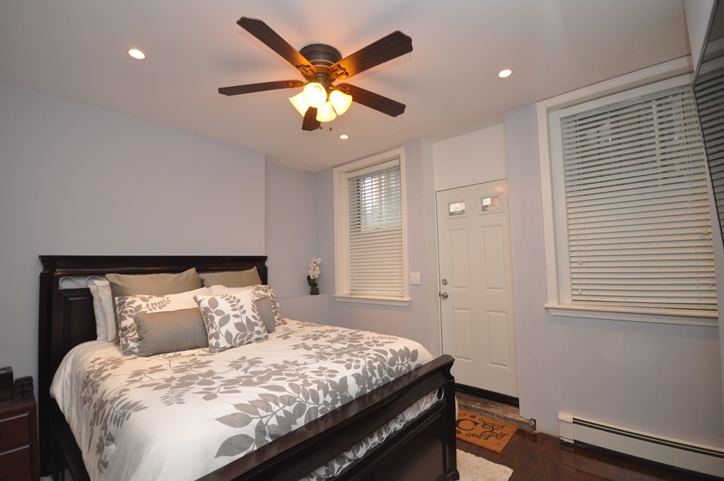 591 Beacon Street, Unit G Boston, MA 02215 - Photo 9 of 9 a bedroom with a large bed and a chandelier