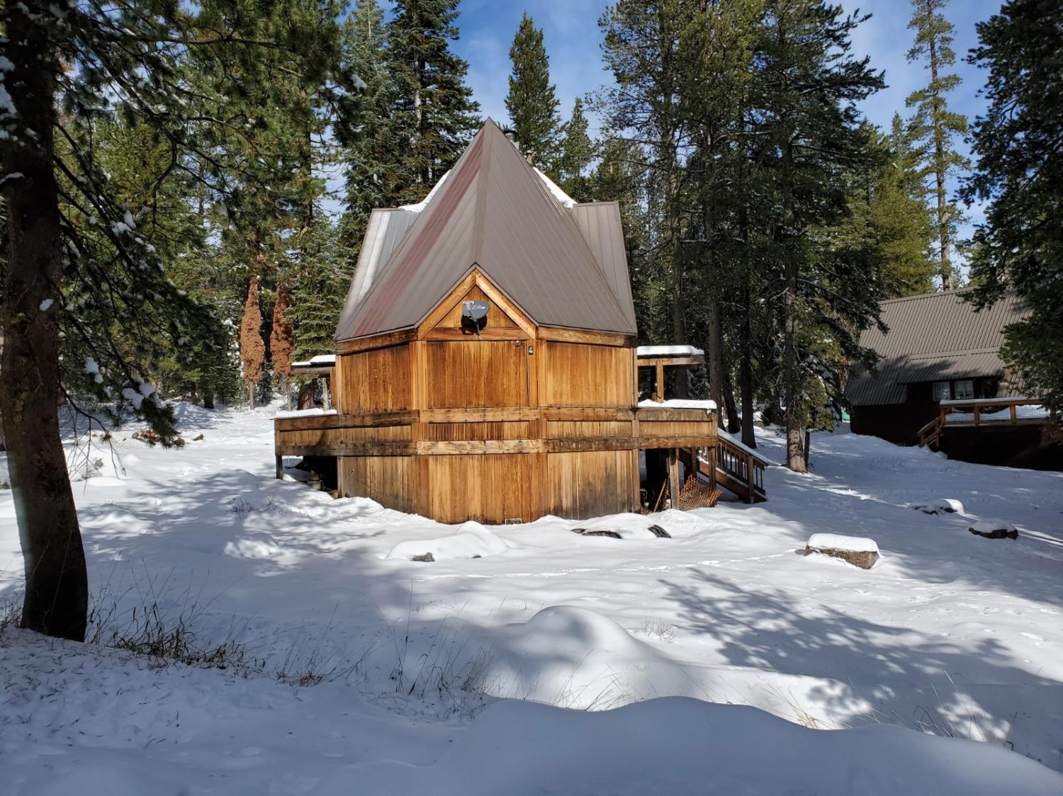 a view of a house with a yard covered in snow
