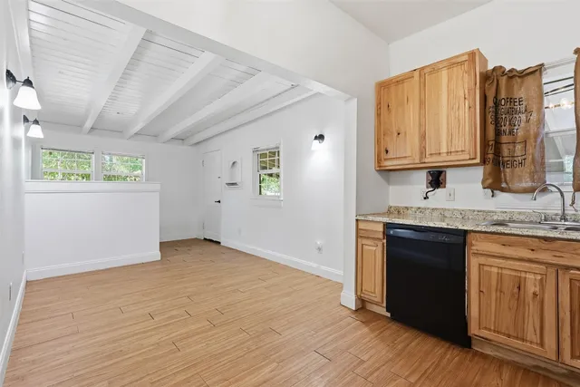 a view of kitchen with granite countertop cabinets and wooden floor