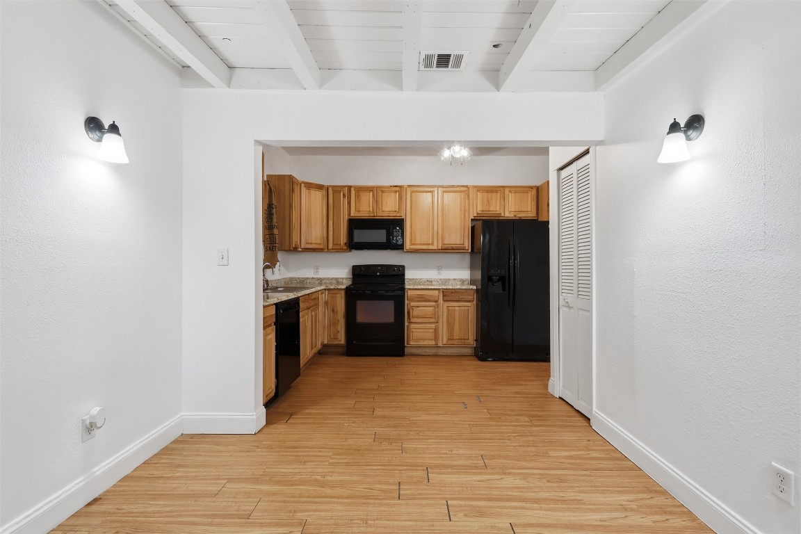 1215 Porter Street Taylor, TX 76574 - Photo 12 of 25 a kitchen with stainless steel appliances a refrigerator and a sink