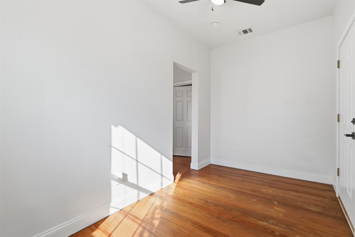1215 Porter Street Taylor, TX 76574 - Photo 3 of 25 a view of a room with wooden floor and white walls