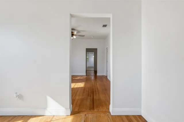 a view of a bathroom from a corridor