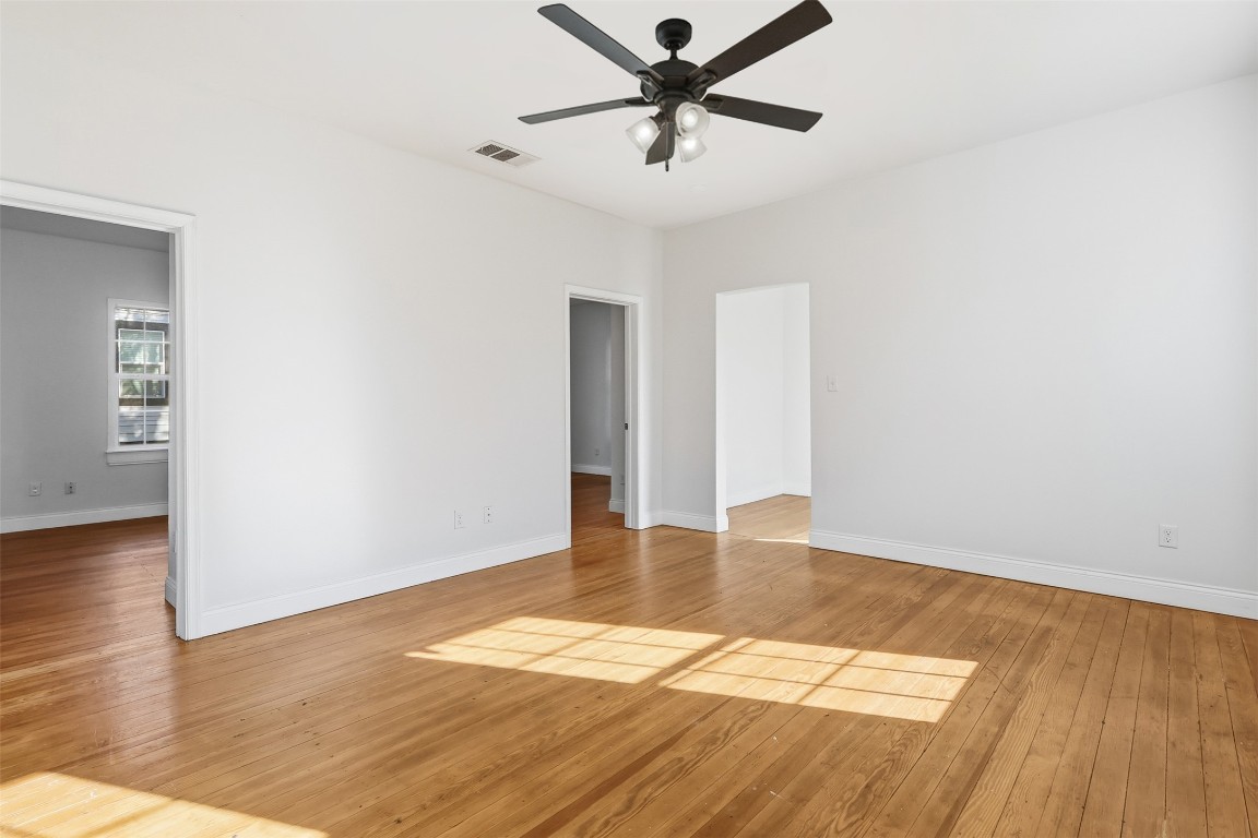 1215 Porter Street Taylor, TX 76574 - Photo 7 of 25 a view of an empty room with wooden floor