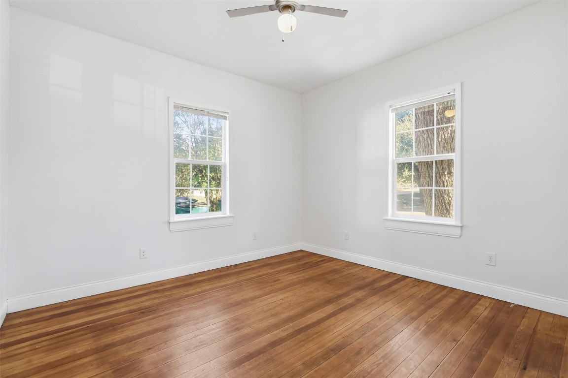 1215 Porter Street Taylor, TX 76574 - Photo 8 of 25 a view of an empty room with wooden floor and a window