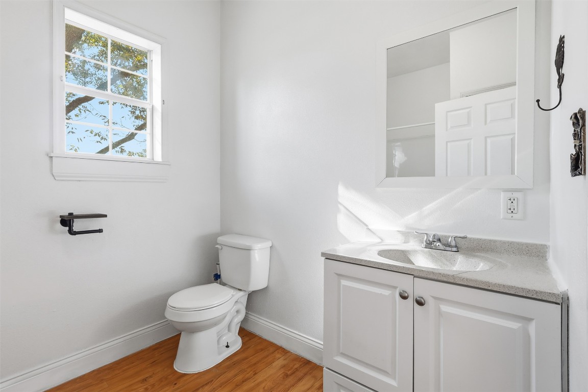 1215 Porter Street Taylor, TX 76574 - Photo 9 of 25 a bathroom with a toilet sink and vanity