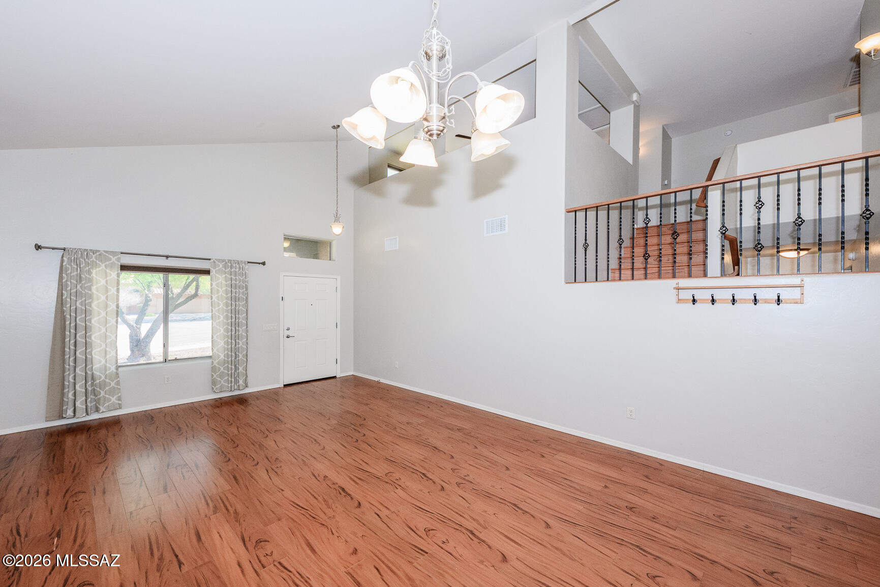 728 South Porter Routh Place Vail, AZ 85641 - Photo 4 of 36 a view of an empty room with wooden floor and a chandelier