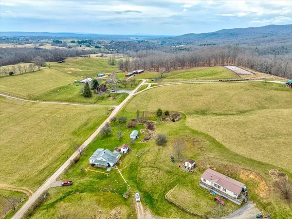an aerial view of a houses with yard
