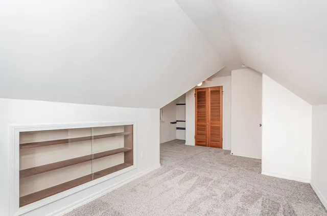 a view of an empty room with a closet