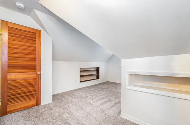 a bathroom with a granite countertop toilet sink and mirror