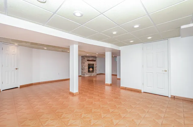 a view of an empty room with a fireplace