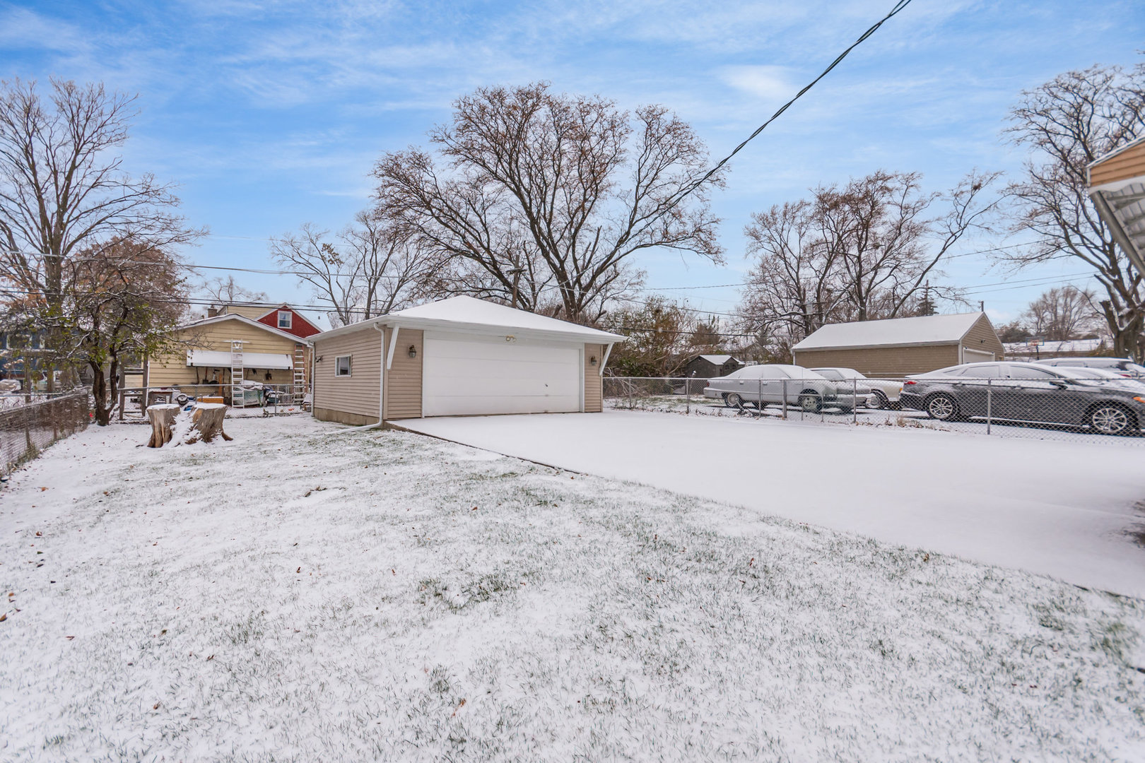 1924 Herbert Avenue Berkeley, IL 60163 - Photo 25 of 29 a view of white house with a yard covered in snow