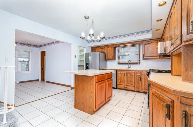 a kitchen with stainless steel appliances granite countertop a sink and cabinets