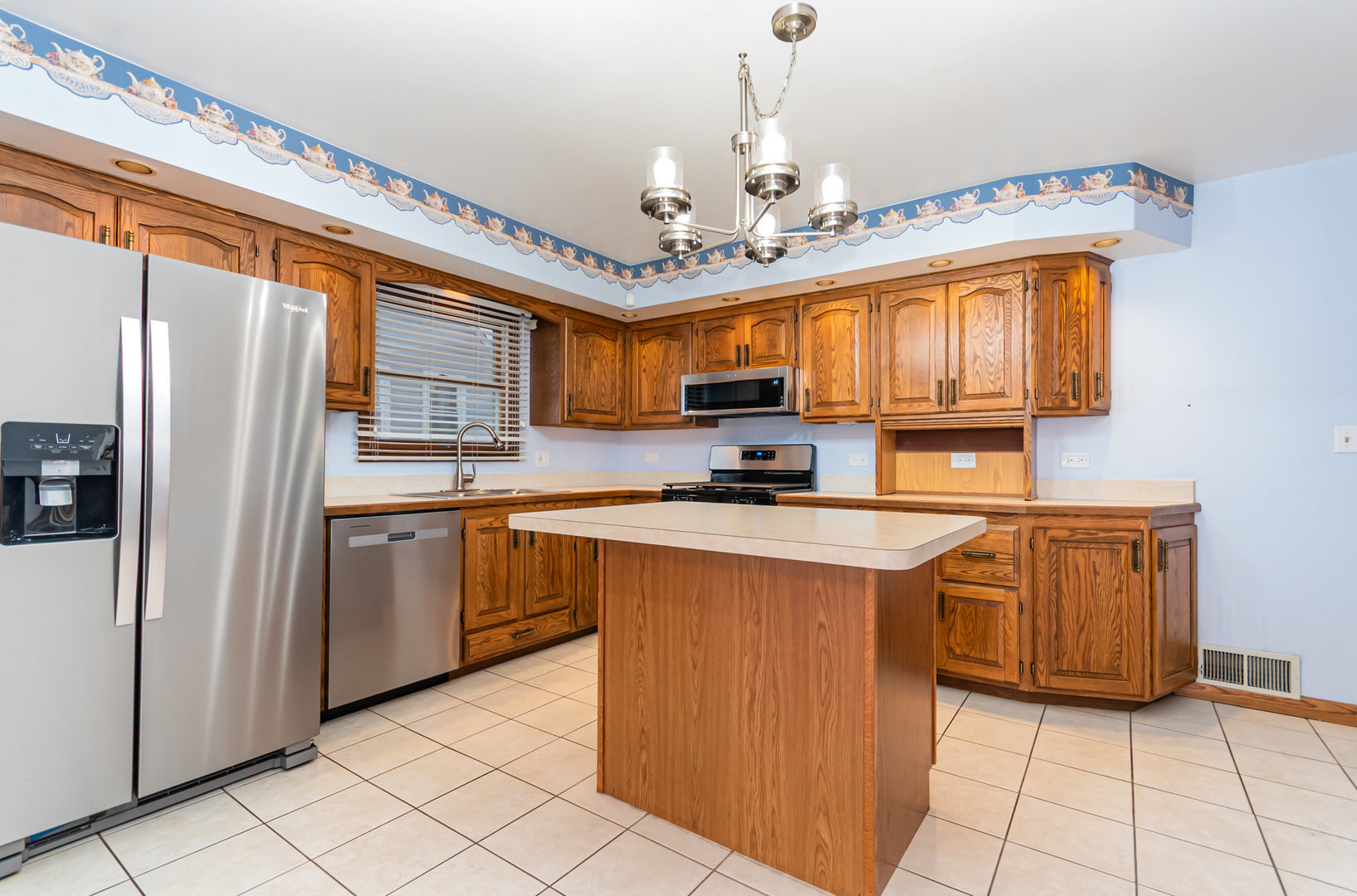 1924 Herbert Avenue Berkeley, IL 60163 - Photo 8 of 29 a kitchen with stainless steel appliances granite countertop a refrigerator a sink dishwasher a stove with wooden cabinets and floor