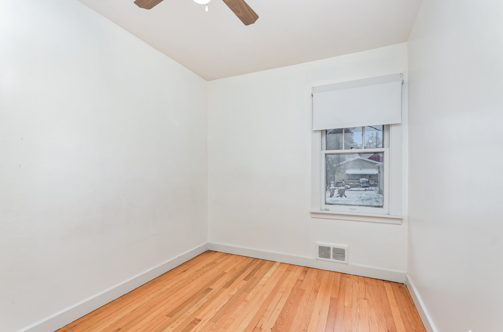 1924 Herbert Avenue Berkeley, IL 60163 - Photo 10 of 29 a view of an empty room with wooden floor and a window