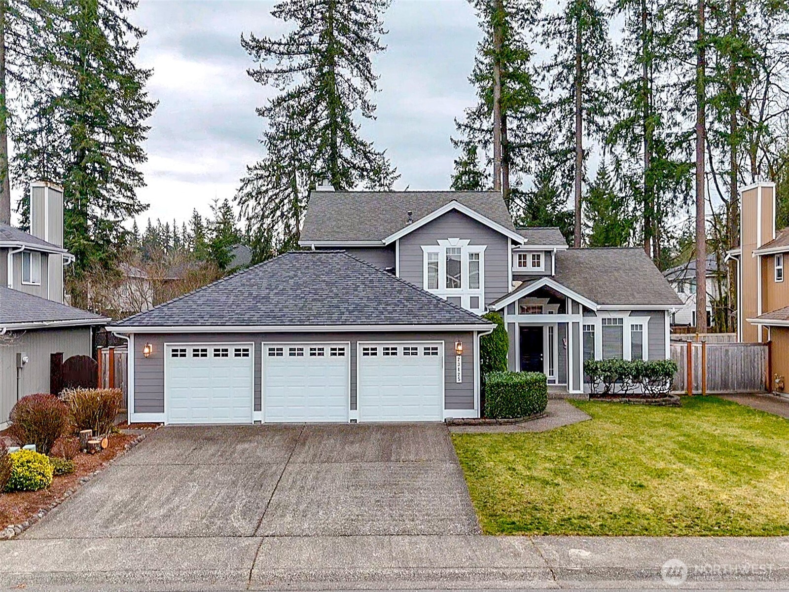 23425 Southeast 248th Street Maple Valley, WA 98038 - Photo 1 of 40 a view of a yard in front of a house with large tree