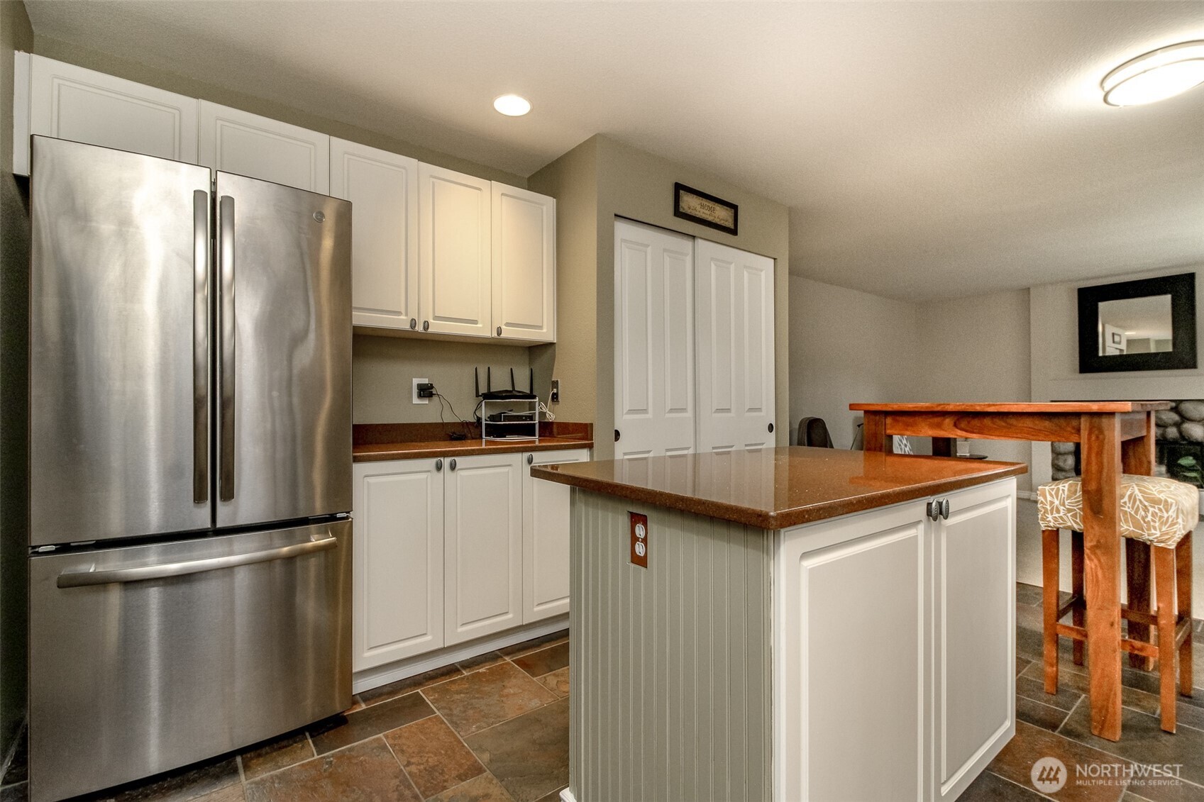 23425 Southeast 248th Street Maple Valley, WA 98038 - Photo 12 of 40 a kitchen with stainless steel appliances granite countertop a refrigerator a sink and white cabinets