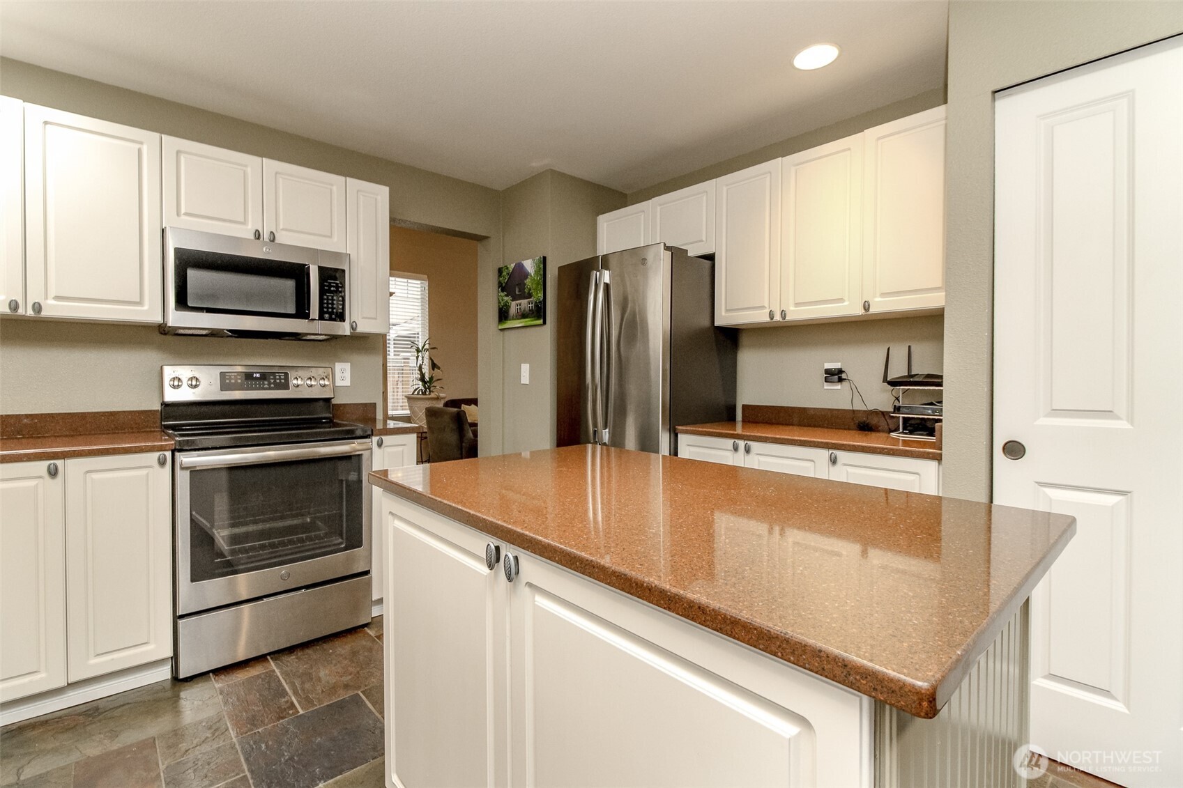 23425 Southeast 248th Street Maple Valley, WA 98038 - Photo 14 of 40 a kitchen with granite countertop a refrigerator stove and microwave