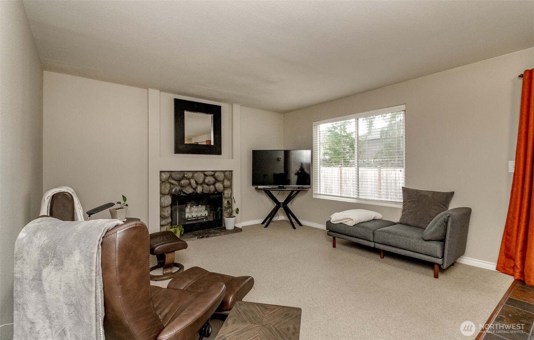 23425 Southeast 248th Street Maple Valley, WA 98038 - Photo 16 of 40 a living room with furniture and a fireplace