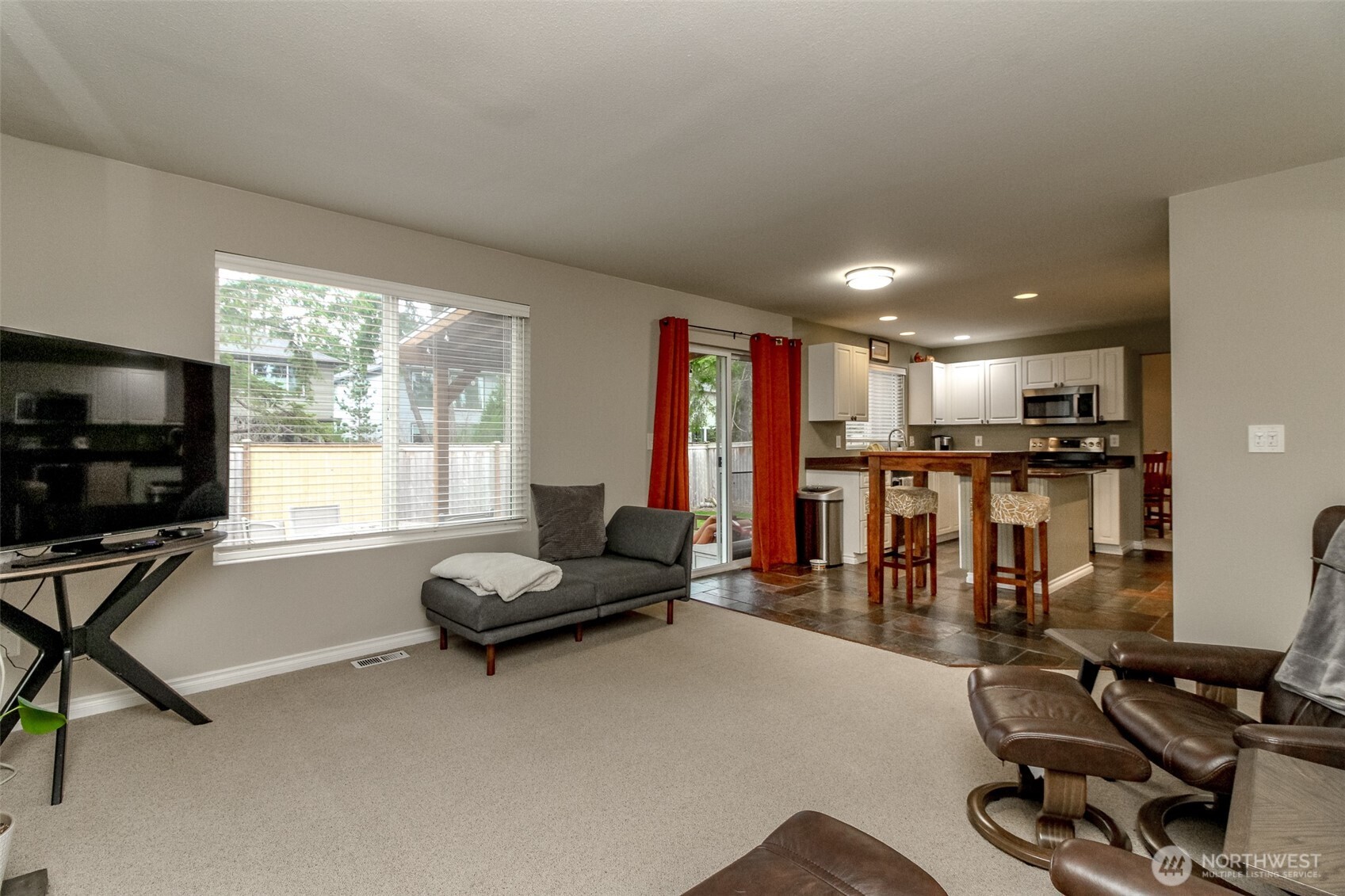 23425 Southeast 248th Street Maple Valley, WA 98038 - Photo 18 of 40 a living room with furniture a window and gym equipment