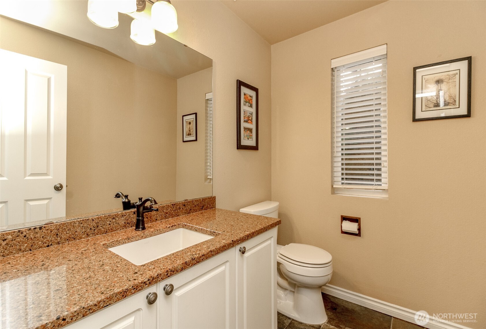 23425 Southeast 248th Street Maple Valley, WA 98038 - Photo 19 of 40 a bathroom with a granite countertop sink vanity mirror and toilet
