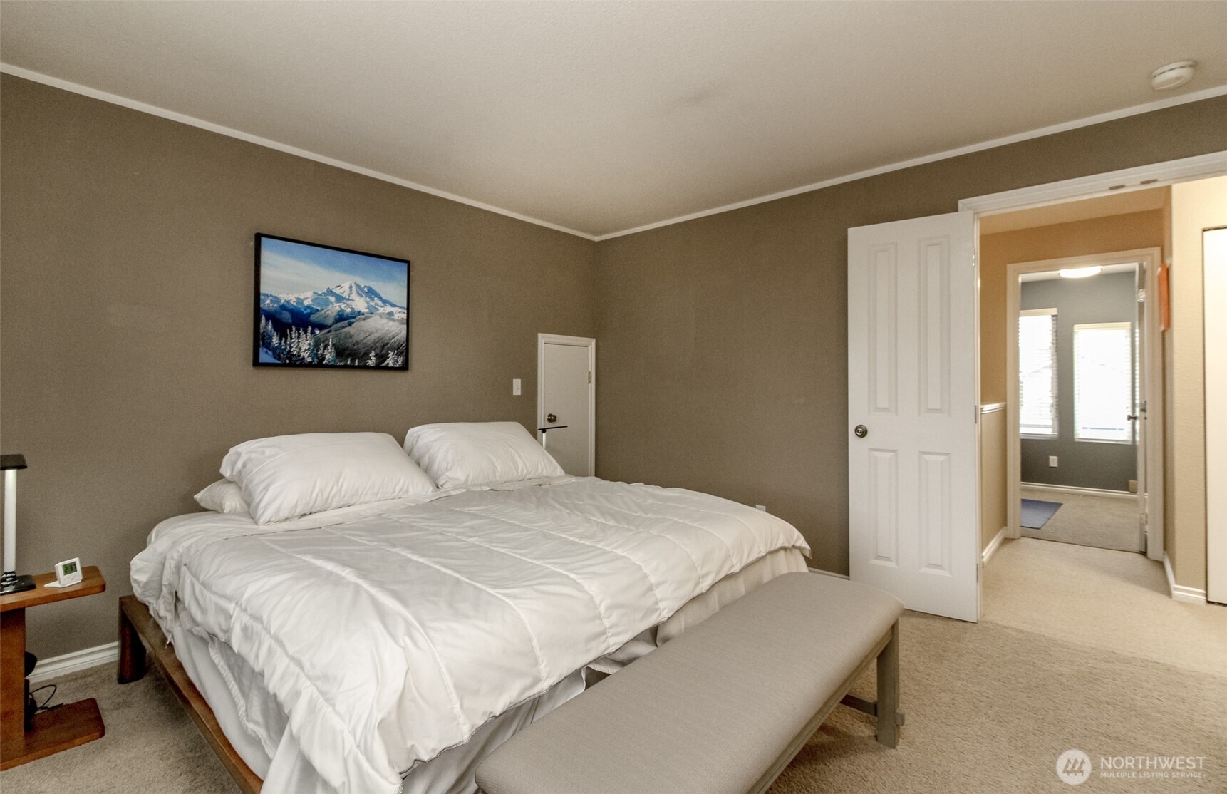 23425 Southeast 248th Street Maple Valley, WA 98038 - Photo 22 of 40 a bedroom with a bed and a painting on the wall