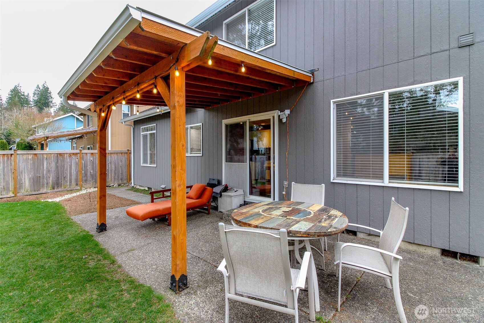 23425 Southeast 248th Street Maple Valley, WA 98038 - Photo 30 of 40 a view of a patio with table and chairs and wooden fence