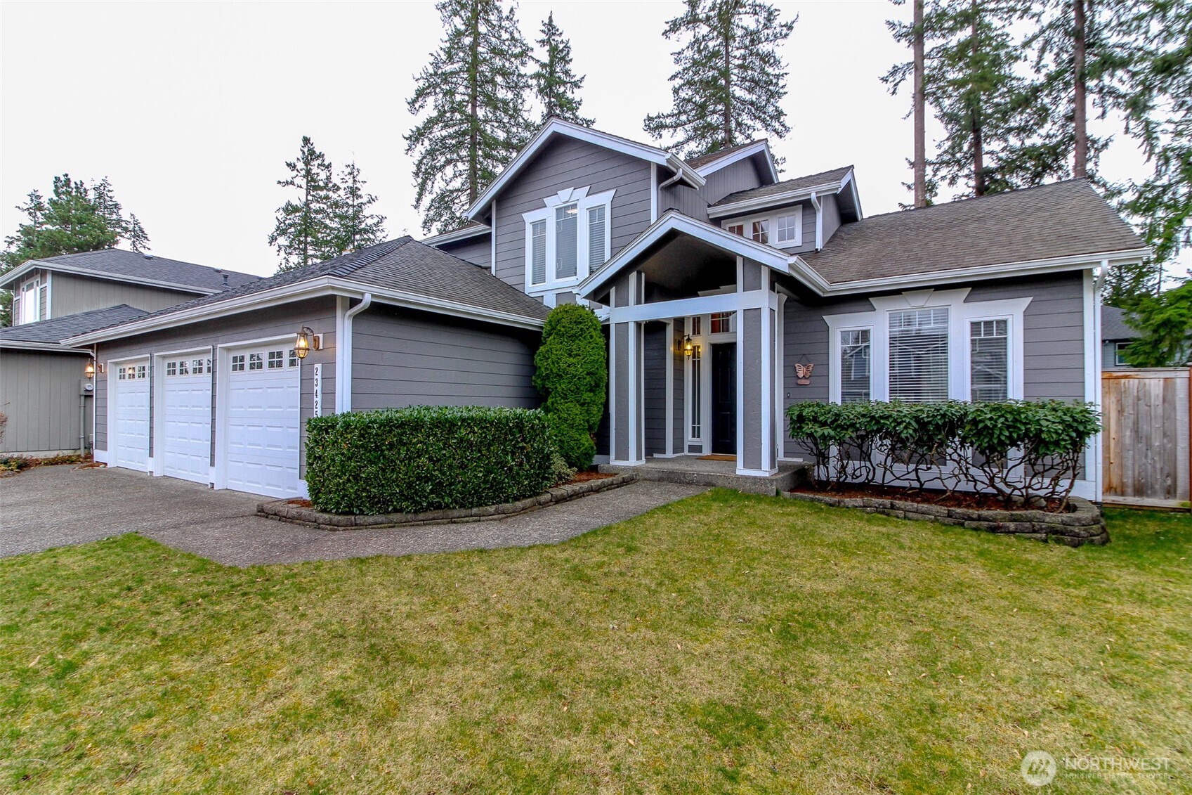 23425 Southeast 248th Street Maple Valley, WA 98038 - Photo 3 of 40 a front view of a house with a yard and garage